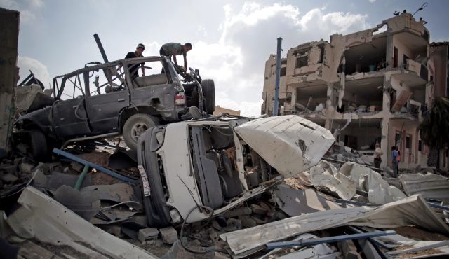 Palestinians search destroyed cars in Rafah's district of Shawkah in the southern Gaza Strip. August 5, 2014. Photo by AP